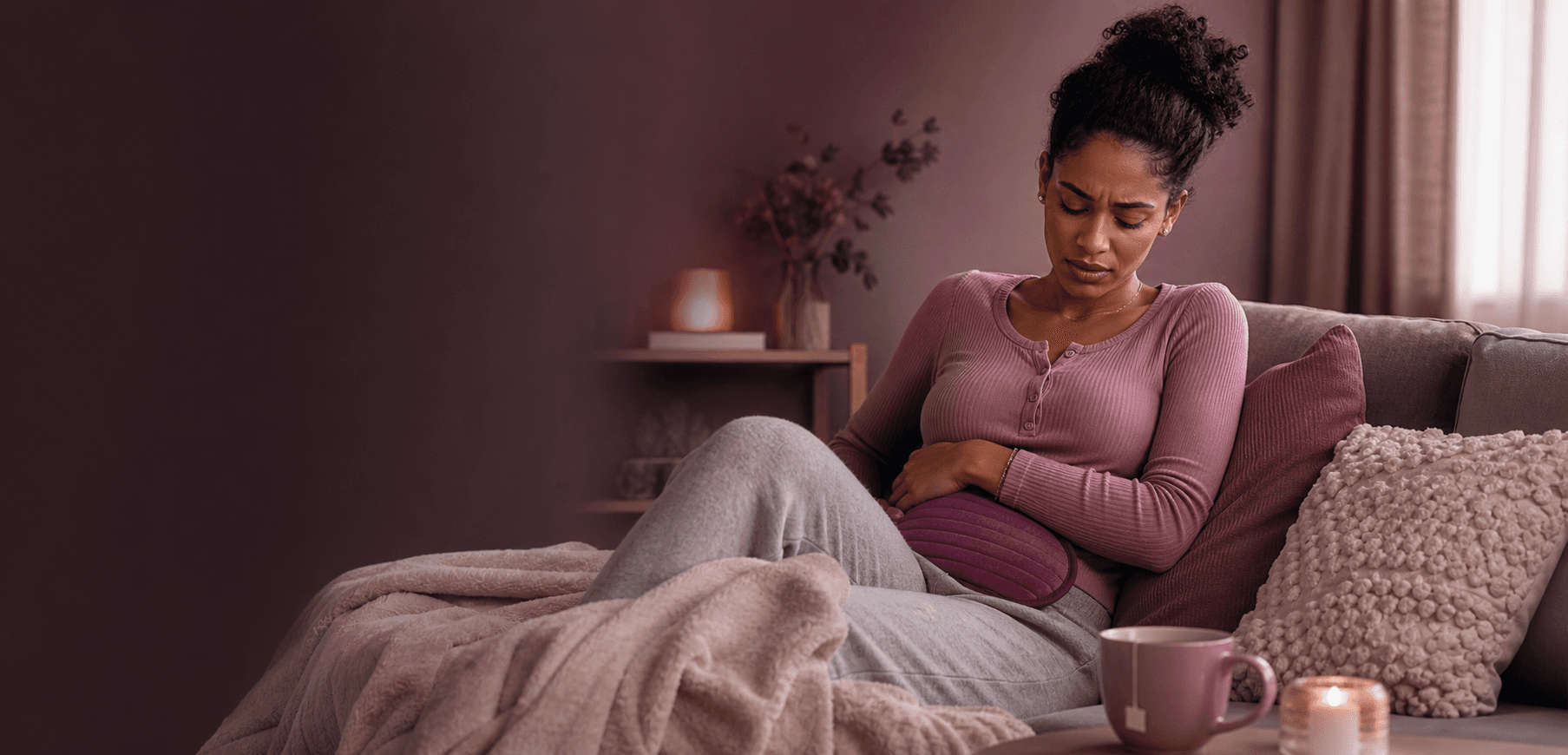 Woman resting at home while experiencing menstrual cramps